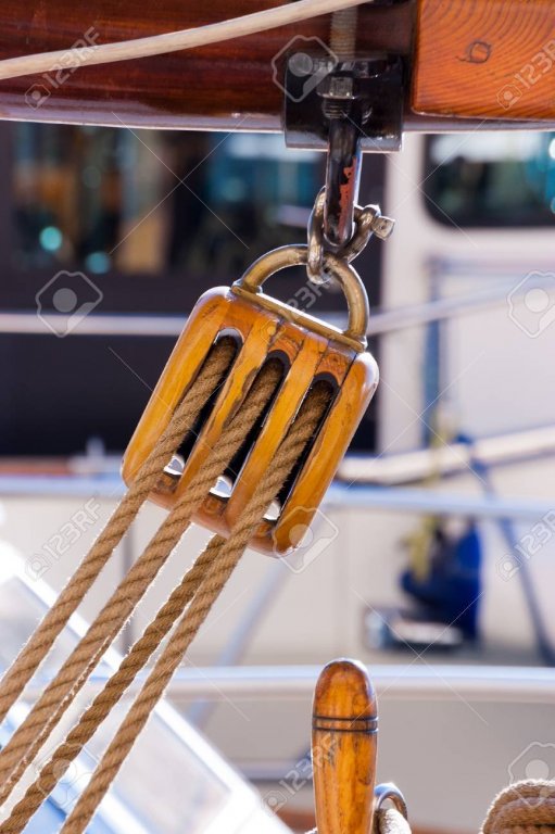 66980608-detail-of-an-old-wooden-pulley-with-ropes-hanging-on-a-boom-of-an-old-sailing-boat.jpg