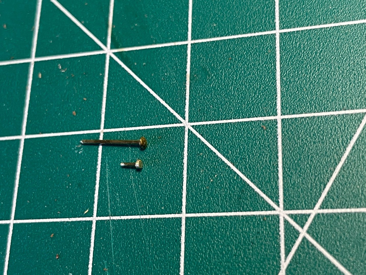 Ground down brass screw for small strap pin