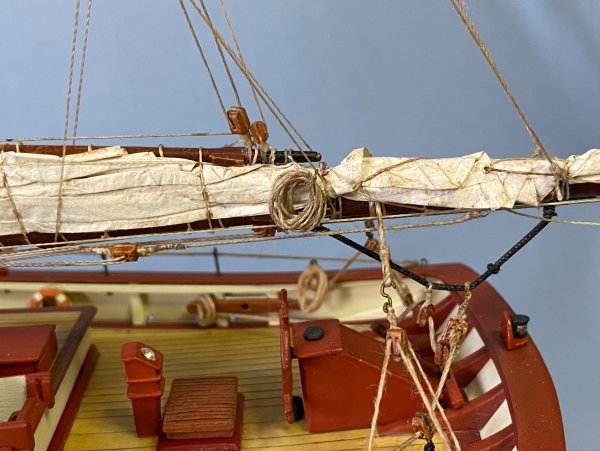 Furled main sail, boom rigging